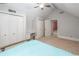 Bedroom with vaulted ceilings, a ceiling fan, and closet doors in a neutral decor at 1565 Kings Xing, Smoke Rise, GA 30087