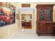 Bright foyer with white tile floors, a striking tapestry, and an antique wood cabinet at 1565 Kings Xing, Smoke Rise, GA 30087