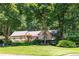 Beautiful one-story home surrounded by a well-manicured lawn and mature trees, offering great curb appeal at 1565 Kings Xing, Smoke Rise, GA 30087
