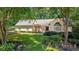 Charming one-story home boasting lush landscaping and mature trees, offering serene curb appeal at 1565 Kings Xing, Smoke Rise, GA 30087