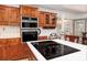 Kitchen with island cooktop and double ovens at 1565 Kings Xing, Smoke Rise, GA 30087
