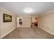 Open-concept living room features neutral paint, white trim, with views of other rooms and hardwood flooring at 1565 Kings Xing, Smoke Rise, GA 30087