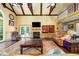 Spacious living room with fireplace, wood beams, and hardwood floors at 1565 Kings Xing, Smoke Rise, GA 30087