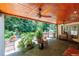 Covered patio with an outdoor kitchen and beautiful landscaping at 1565 Kings Xing, Smoke Rise, GA 30087