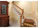 Elegant staircase with carpet runner and white painted risers leading to upper level at 1565 Kings Xing, Smoke Rise, GA 30087