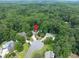 A bird's eye view of a red brick house nestled in a lush green landscape with a swimming pool at 505 Armor Knl, Powder Springs, GA 30127