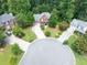 Aerial view of a brick home on a cul-de-sac with a long driveway surrounded by mature trees at 505 Armor Knl, Powder Springs, GA 30127