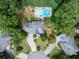 Overhead view of home with swimming pool, patio furniture, swing set, and lots of trees at 505 Armor Knl, Powder Springs, GA 30127