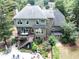 Exterior of home featuring a deck, patio, beautiful landscaping, and mature trees at 505 Armor Knl, Powder Springs, GA 30127