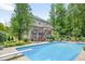 Great view of the backyard pool and house from the corner of the yard at 505 Armor Knl, Powder Springs, GA 30127