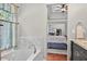 A bathroom featuring a soaking tub and views into the main bedroom and home office at 505 Armor Knl, Powder Springs, GA 30127