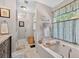 Bathroom featuring a soaking tub and a view into the hallway at 505 Armor Knl, Powder Springs, GA 30127
