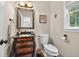 Elegant half-bathroom features a decorative vanity with marble top and a window with natural light at 505 Armor Knl, Powder Springs, GA 30127