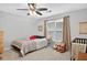 Bright bedroom with a ceiling fan, window, curtains, carpeted floors and a single bed at 505 Armor Knl, Powder Springs, GA 30127