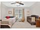 Bright bedroom with a ceiling fan, window, curtains, carpeted floors and a single bed and crib at 505 Armor Knl, Powder Springs, GA 30127