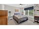 Cozy bedroom with a ceiling fan, built-in shelves, and a large window with natural light at 505 Armor Knl, Powder Springs, GA 30127
