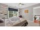 Comfortable bedroom with large window, built-in shelves, ceiling fan, and neutral carpeting at 505 Armor Knl, Powder Springs, GA 30127
