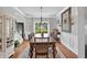 Elegant dining room with hardwood floors, a decorative rug, and a stylish chandelier for sophisticated meals at 505 Armor Knl, Powder Springs, GA 30127