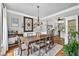 Elegant dining room featuring a wooden table, chandelier, and an open view into the kitchen at 505 Armor Knl, Powder Springs, GA 30127