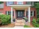 Charming front porch with stone steps, elegant black double doors, and decorative potted plants at 505 Armor Knl, Powder Springs, GA 30127