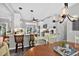 Open kitchen with granite countertops, white cabinets, stainless appliances and eat at barstools at 505 Armor Knl, Powder Springs, GA 30127