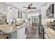 Well-lit kitchen showcasing a granite island, stainless steel appliances, white cabinets, and slate floors at 505 Armor Knl, Powder Springs, GA 30127