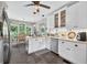 Inviting kitchen featuring white cabinets, granite countertops, stainless steel appliances, and slate floors at 505 Armor Knl, Powder Springs, GA 30127