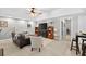 Open concept living room with comfortable furniture, area rug, wood trim, large TV and recessed lighting at 505 Armor Knl, Powder Springs, GA 30127