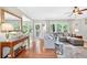 Open-concept living room with hardwood floors, stylish decor, and large windows offering wooded views at 505 Armor Knl, Powder Springs, GA 30127