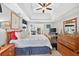 Spacious main bedroom with tray ceilings, hardwood floors and large wood dresser at 505 Armor Knl, Powder Springs, GA 30127