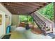 Covered patio area featuring a hot tub, grill, and access to the backyard at 505 Armor Knl, Powder Springs, GA 30127
