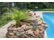 Rock feature and landscaping add charm to the beautiful pool area at 505 Armor Knl, Powder Springs, GA 30127