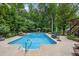 Large pool with patio and lush landscaped backyard, perfect for relaxation at 505 Armor Knl, Powder Springs, GA 30127