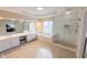 Elegant bathroom featuring double sinks, soaking tub, and glass enclosed shower at 5347 Harbury Cv, Suwanee, GA 30024