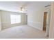 Spacious bedroom with carpet floors, neutral colored walls, and a ceiling fan at 5347 Harbury Cv, Suwanee, GA 30024