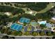 Aerial shot of neighborhood tennis courts, basketball court, pool, playground, and parking area at 5347 Harbury Cv, Suwanee, GA 30024