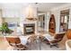 Cozy sitting area with a fireplace, wooden accents, and great natural light at 5347 Harbury Cv, Suwanee, GA 30024