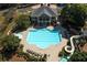 Aerial view of a large community pool area with a slide and ample seating for residents at 5347 Harbury Cv, Suwanee, GA 30024