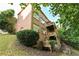 Back of brick home featuring multilevel decks and stairs surrounded by a wooded yard with fire pit at 5347 Harbury Cv, Suwanee, GA 30024