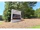 Sign for Riverside Elementary School with surrounding trees and well-maintained grounds at 5347 Harbury Cv, Suwanee, GA 30024