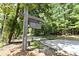 Settles Bridge sign surrounded by natural forest, offering recreational activities for residents at 5347 Harbury Cv, Suwanee, GA 30024