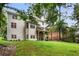 The backyard features a spacious lawn, mature trees, and a deck overlooking the scenery at 6380 Bannerhorn Run, Alpharetta, GA 30005