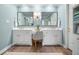 Bright bathroom featuring dual sinks, white cabinets, and framed mirrors for a modern, clean aesthetic at 6380 Bannerhorn Run, Alpharetta, GA 30005