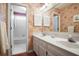 Traditional bathroom featuring a double vanity, floral wallpaper, and a separate shower/tub area at 6380 Bannerhorn Run, Alpharetta, GA 30005