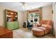 Cozy bedroom with a comfortable armchair, desk, and built-in bookshelves for a relaxing workspace at 6380 Bannerhorn Run, Alpharetta, GA 30005