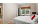 Cozy bedroom features a built-in desk area, window with wooden blind, and neutral decor at 6380 Bannerhorn Run, Alpharetta, GA 30005