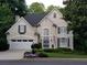 Charming two-story home featuring a well-manicured lawn, attached garage, and stately curb appeal at 6380 Bannerhorn Run, Alpharetta, GA 30005