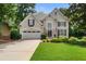 Charming two-story home with a well-manicured lawn, attached garage, and beautifully landscaped front yard at 6380 Bannerhorn Run, Alpharetta, GA 30005