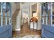 Elegant foyer with hardwood floors, staircase, and views into other rooms at 6380 Bannerhorn Run, Alpharetta, GA 30005