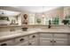 Kitchen counter with view of the living room and white cabinetry and stainless steel appliances at 6380 Bannerhorn Run, Alpharetta, GA 30005